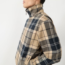 Model wearing Barbour Casual Jacket in Birchwood Dress Tartan, beige and navy check, shown from side with high collar zip detail.