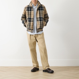 Model wearing Barbour Birchwood Dress Tartan casual jacket, styled with a light blue shirt and beige chinos