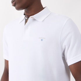 Model wearing Barbour polo in white, short sleeves, piqu&eacute; cotton fabric with embroidered logo on chest.