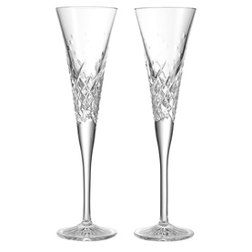 Waterford clear crystal champagne flutes, pair, with diamond-cut detailing on the bowl and slender stem, on white background.