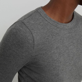 Model wearing Reiss grey marl fine-knit crew neck long sleeve top, close-up detail of shoulder and sleeve.
