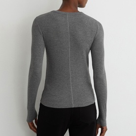 Model wearing Reiss grey marl long-sleeve fitted top, shown from the back with a centre seam detail, paired with black trousers.