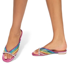 Model wearing Kurt Geiger London multi rainbow sequin flat mule sandals with crystal embellished crossover strap and pink sole.