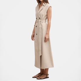 Model wearing sleeveless beige double-breasted belted midi dress with lapel collar, styled with brown strappy flat sandals