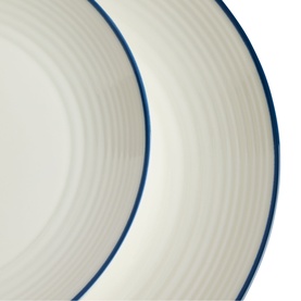 Gordon Ramsay pasta bowl in cream with blue rim detail, showing ribbed texture interior, close-up view