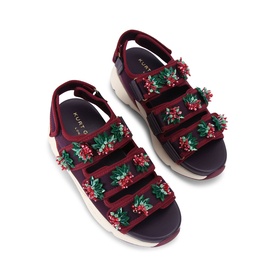Kurt Geiger London red sandals with floral embellishments across three velcro straps, chunky white sole and ankle strap.