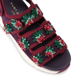 Kurt Geiger London red sandals with velcro straps, floral berry embellishments in green and red, white flatform sole, overhead view.