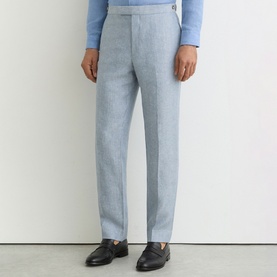 Model wearing Reiss soft blue tailored trousers with a slim fit, styled with black leather loafers and a light blue jumper.