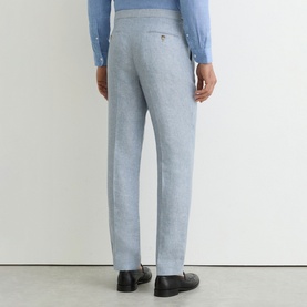 Model wearing Reiss soft blue tailored trousers, rear view, styled with a light blue shirt and black loafers