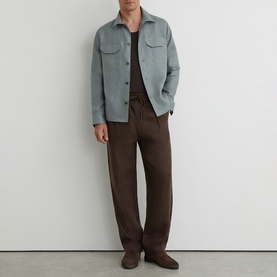 Model wearing Reiss midnight green overshirt jacket with brown trousers and matching suede loafers