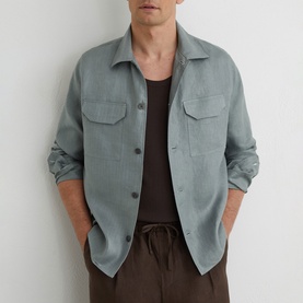 Model wearing Reiss midnight green overshirt with chest pockets, styled with dark vest and brown drawstring trousers