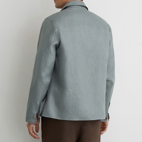 Model wearing Reiss midnight green linen-look overshirt jacket, back view, styled with brown trousers