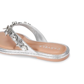Carvela silver flat sandal with crystal and floral embellishment on toe-post strap, silver glitter sole, angled back view