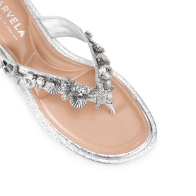 Marvela silver flat thong sandal with crystal and shell embellishments along the strap, metallic finish