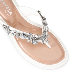Marvela white flat thong sandal with silver sea creature embellishments including starfish, shells and coral across the strap.