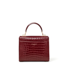 Aspinal of London merlot croc-effect leather top handle bag with gold hardware and structured silhouette