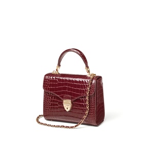 Aspinal of London merlot croc-effect structured top-handle bag with gold chain strap and front clasp fastening