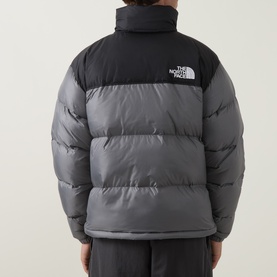 Model wearing North Face casual jacket in Smoked Pearl and TNF Black, quilted puffer style with contrast black yoke, back view.