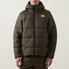 Model wearing North Face casual jacket in New Taupe Green, hooded puffer style with quilted panels and branded chest patch.