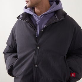 Model wearing North Face Obsidian casual jacket in nylon-cotton blend, styled with a purple hoodie underneath, close-up detail view