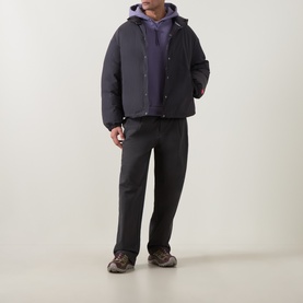 Model wearing The North Face Obsidian casual jacket with purple hoodie, dark trousers and brown trainers