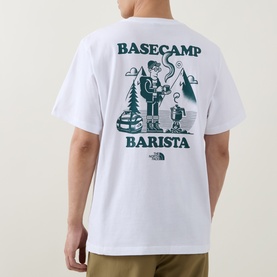 Model wearing North Face Basecamp Barista white crew neck T-shirt, back view showing teal graphic print of camper with coffee