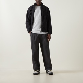 Model wearing North Face Evolution Box Logo Back Graphic T-Shirt in Cumulus Cloud, styled with black zip fleece and dark trousers.