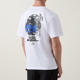 Model wearing North Face white cotton crew neck T-shirt, back view showing blue mountaineer graphic print