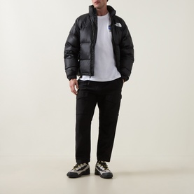 Model wearing North Face TNF White crew neck cotton T-shirt, styled with black puffer jacket, black trousers, and hiking shoes.
