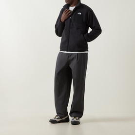 Model wearing North Face Yumiori Half-Zip Fleece Sweatshirt in TNF Black with zipped chest pocket, styled with dark trousers and trail shoes.