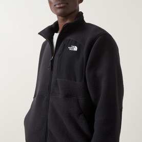 Model wearing North Face Yumiori Half-Zip Fleece Sweatshirt in TNF Black with zip chest pocket and embroidered logo detail.