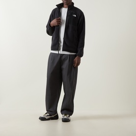 Model wearing North Face Yumiori Half-Zip Fleece Sweatshirt in TNF Black with matching dark trousers and trail shoes.