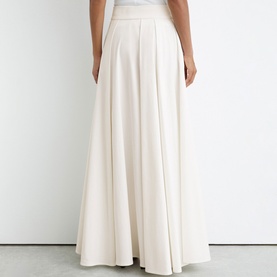 Model wearing Reiss white full-length pleated maxi skirt with wide waistband, rear view showing voluminous A-line silhouette