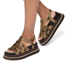 Model wearing Kurt Geiger London multi metallic gold gladiator flatform sandals with black chunky sole and buckle strap detail