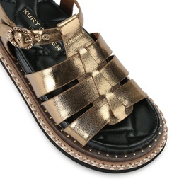Kurt Geiger London gold metallic strappy flatform sandal with ornate buckle detail, studded chunky sole and black footbed