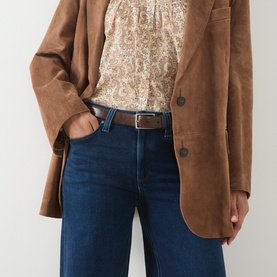 Model wearing Paige Straight Jeans in Basillica dark blue denim, styled with a tan suede blazer and paisley blouse