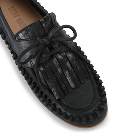 Steve Madden black leather moccasin loafer with fringe detail, lace tie, and contrast stitched rubber sole