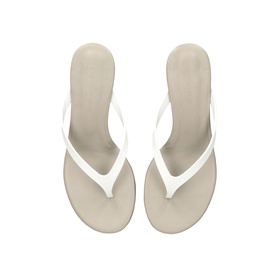 Christopher Esber white thong sandals with slim toe-post strap and low wedge heel, shot from above on neutral background.