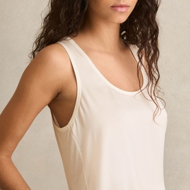 Model wearing Reiss white sleeveless scoop-neck vest top, relaxed fit with wide straps, close-up detail view
