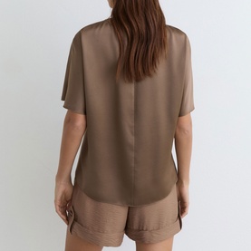 Model wearing Reiss taupe brown short-sleeve satin blouse, back view, styled with matching satin shorts.