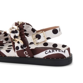 Carvela white and brown polka dot flat sandal with gold-tone buckle hardware, black sole, close-up detail view