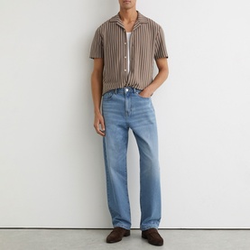 Model wearing Reiss brown striped short-sleeve shirt, styled with light wash straight-leg jeans and dark brown loafers.