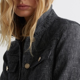 Model wearing Reiss blue textured woven jacket, close-up of collar and gold-tone button detail