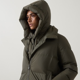 Model with Yves Salomon Padded Hood Bib in Herbal Tea, sleeveless quilted down-filled design with adjustable drawstring hood, tonal hardware