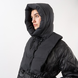 Model with Yves Salomon Padded Hood Bib in black, showing quilted down-filled hood with adjustable drawstring and sleeveless design