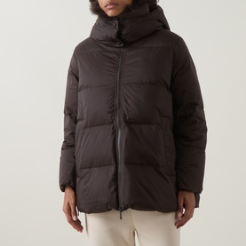 Model wearing Yves Salomon cold brew quilted down hooded jacket with zip fastening, styled with cream trousers