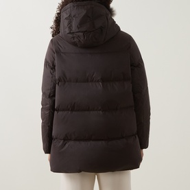 Model wearing Yves Salomon jacket in Cold Brew, rear view, quilted puffer silhouette with fur-trimmed hood and mid-length cut.