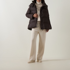 Model wearing Yves Salomon cold brew padded jacket with funnel neck, styled with cream roll-neck and wide-leg trousers