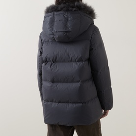 Model wearing Yves Salomon grey padded jacket, rear view, with fur-trimmed hood and quilted panelling