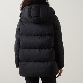 Model wearing Yves Salomon A-Line Down Jacket in black, rear view showing removable hood, quilted panels and A-line silhouette
